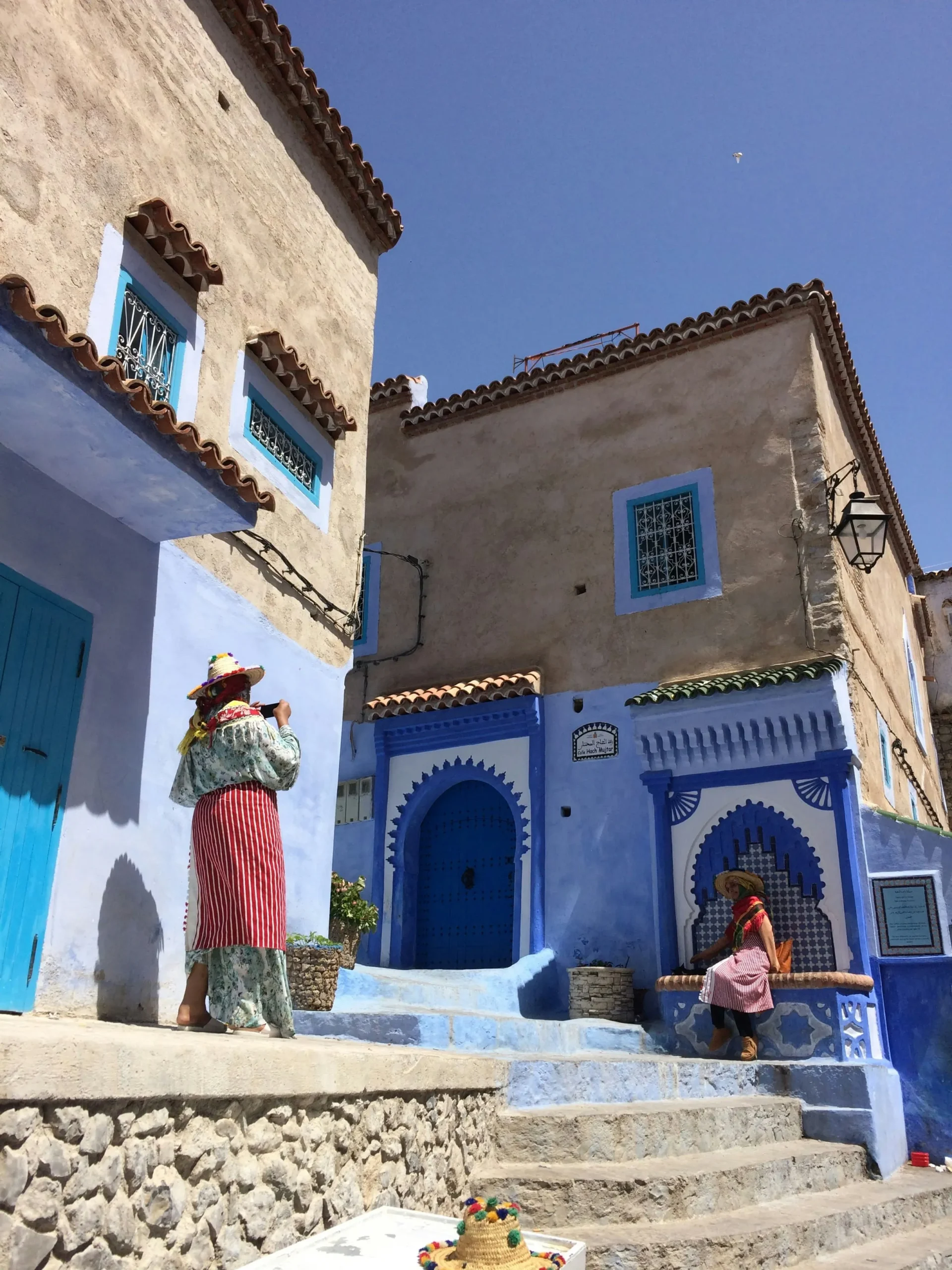 Blue Doors and Moroccan Architecture Women exploring a traditional blue Moroccan house in Chefchaouen