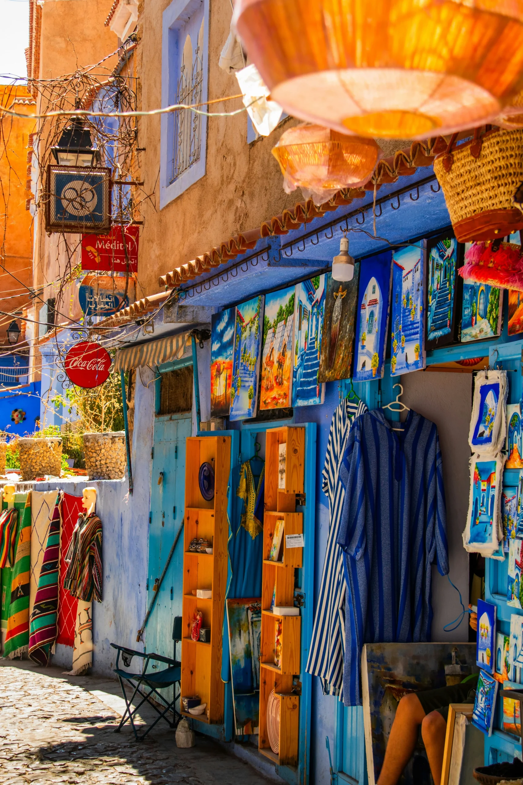 Moroccan Art and Handicrafts in Chefchaouen Local art and souvenirs displayed on blue walls in the medina of Chefchaouen