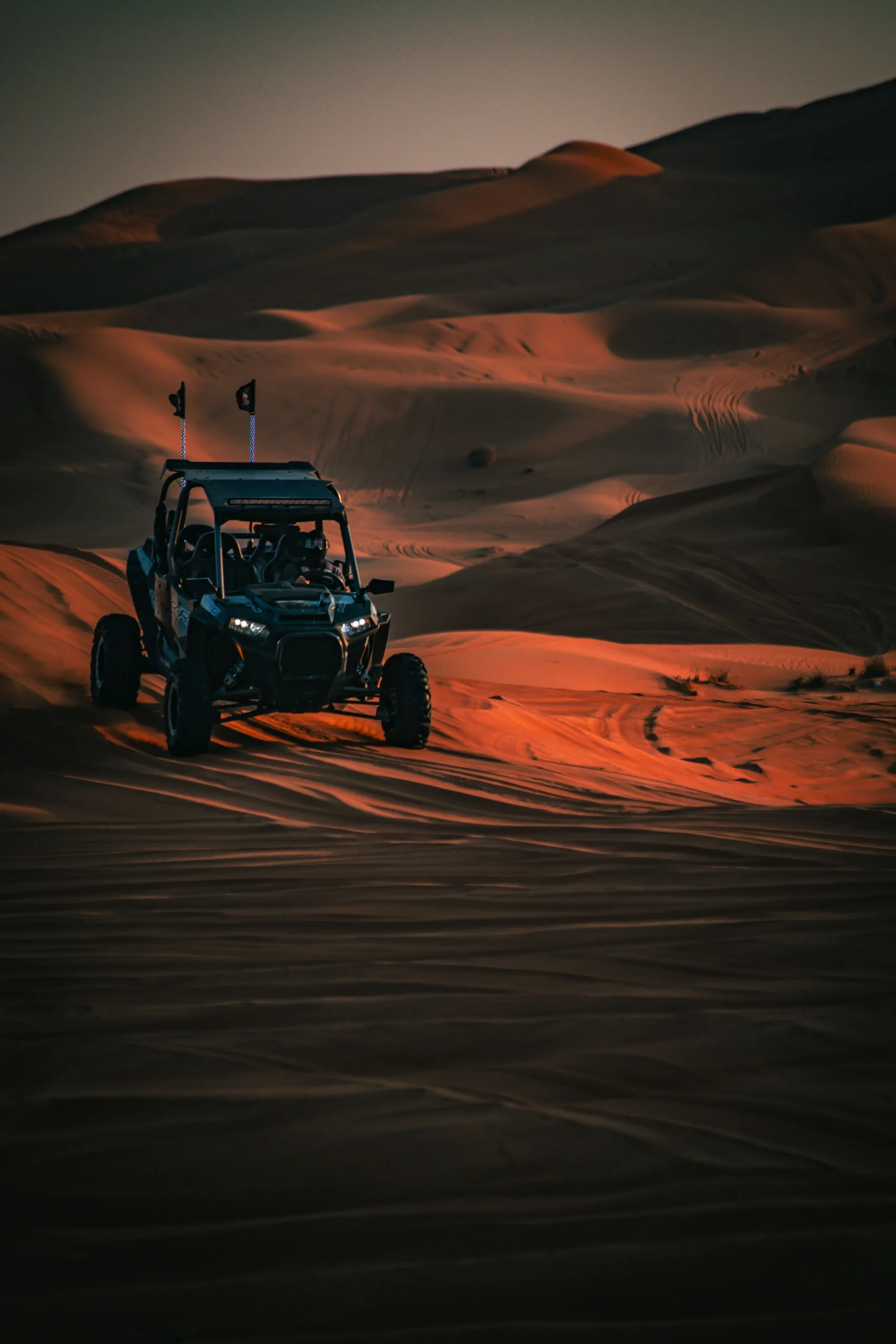 Desert Buggy Adventure in Merzouga, Morocco Traveler driving a buggy through the high sand dunes of Merzouga Desert, Morocco